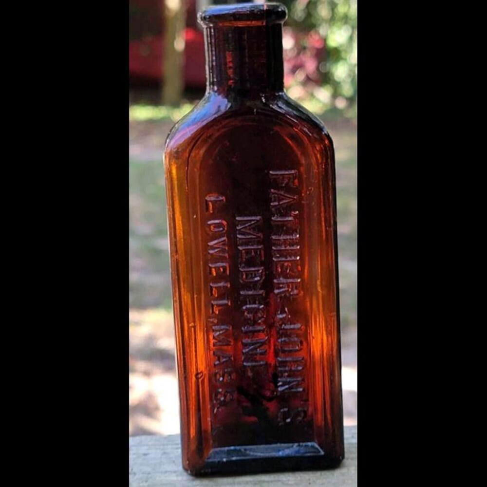 ANTIQUE FATHER JOHN'S MEDICINE BOTTLE LOWELL  MASS MADE IN USA DARK AMBER 9-1/2”
